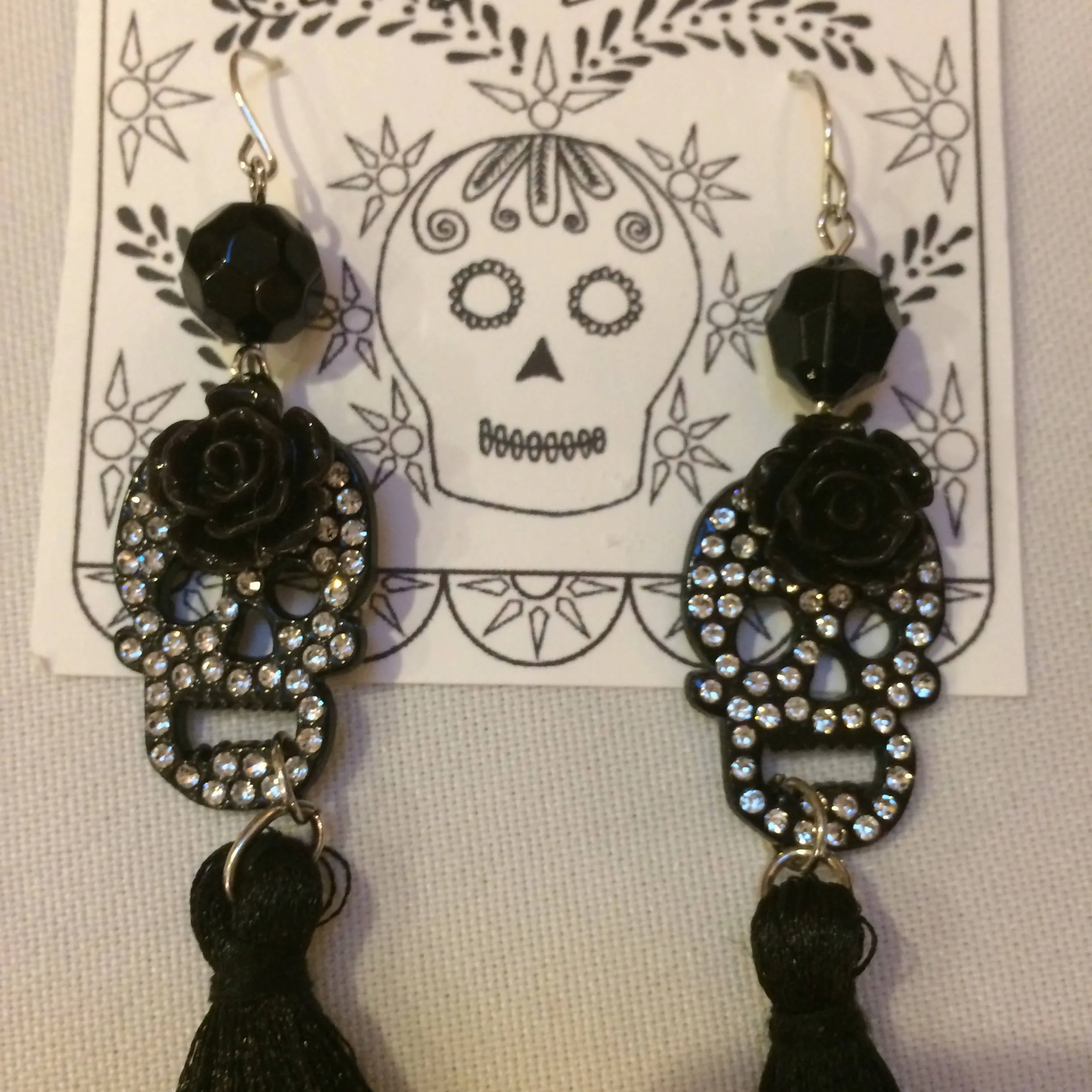 Maggie Devos - Rhinestone skull earrings w/ black tassels